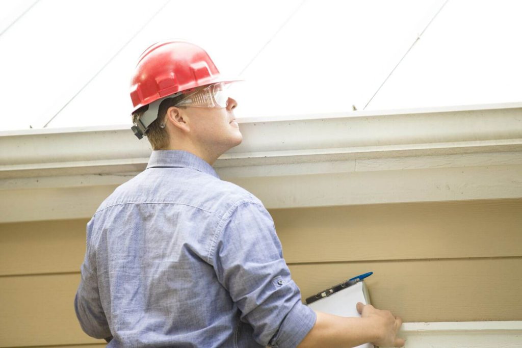 A building inspector examining a roof