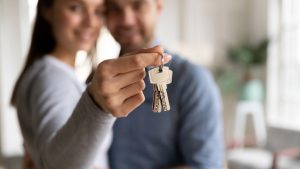 Couple holding keys to a new home